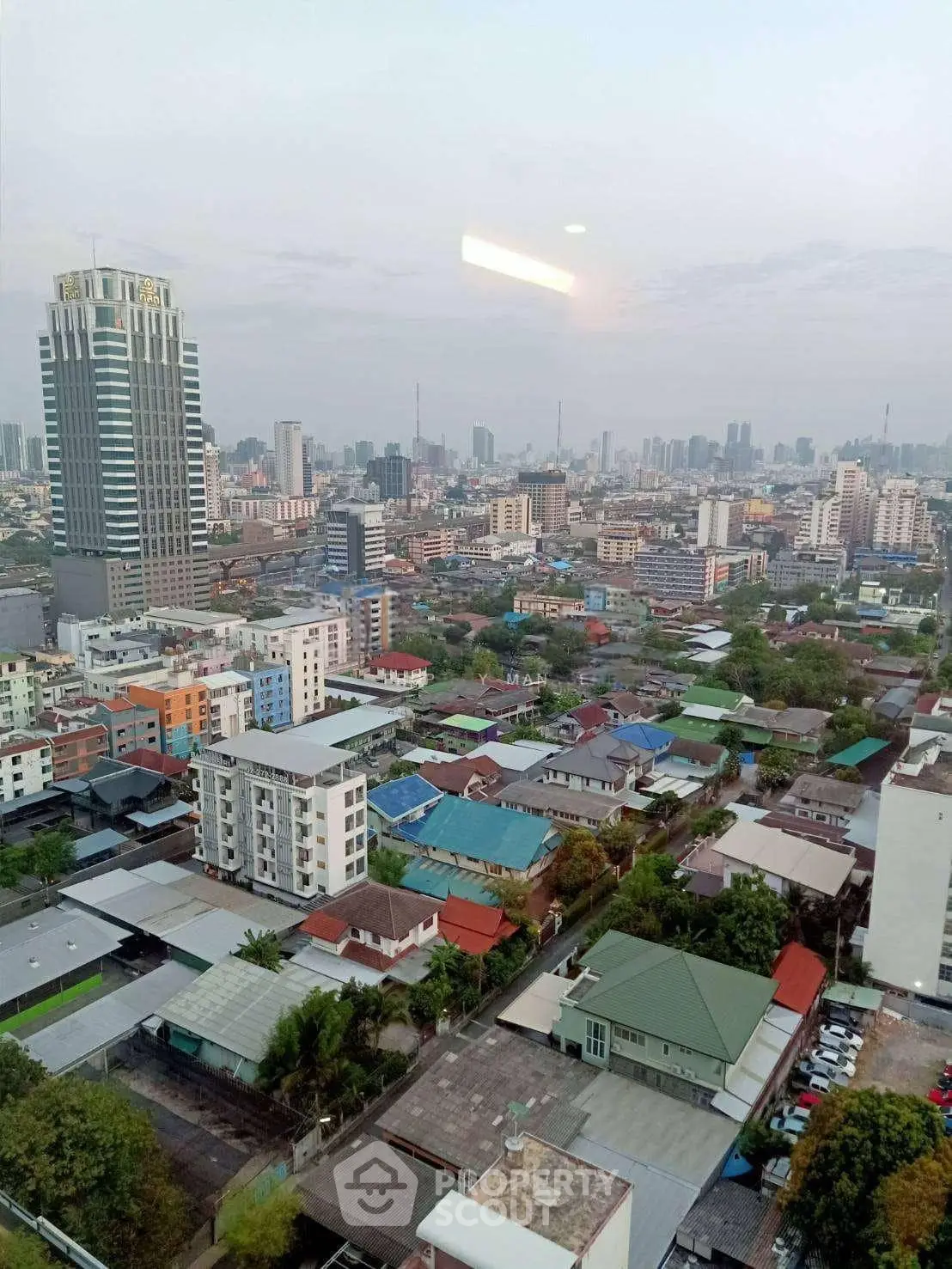 Stunning cityscape view from high-rise building showcasing urban skyline and residential areas.