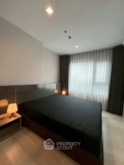 Modern bedroom with sleek design and large window for natural light