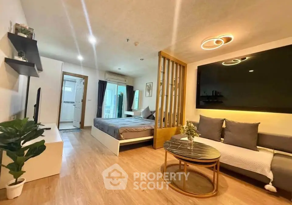 Modern studio apartment with stylish decor and open layout, featuring cozy living area and bedroom.
