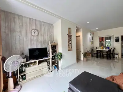 Spacious living room with modern decor and open dining area, perfect for family gatherings.