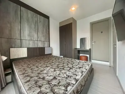 Modern bedroom with stylish decor and comfortable bed in a contemporary apartment.