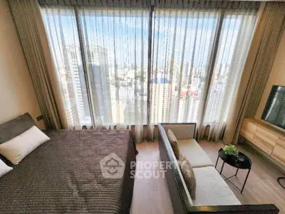 Luxurious bedroom with stunning city view, featuring modern decor and floor-to-ceiling windows.