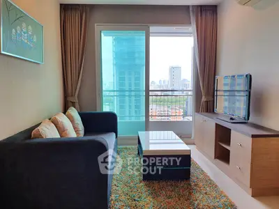 Modern living room with city view, stylish furniture, and vibrant decor in a high-rise apartment.