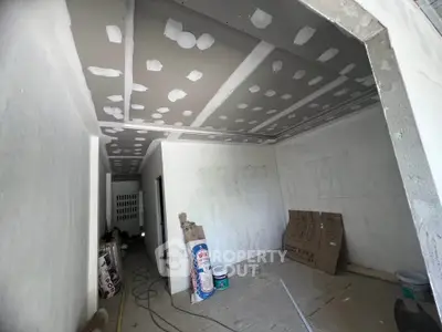 Under-construction interior space with drywall and construction materials, ideal for customization.