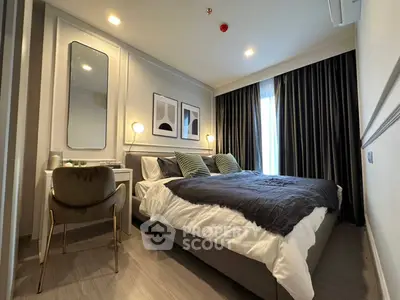Modern bedroom with stylish decor, featuring a cozy bed, elegant lighting, and contemporary artwork.
