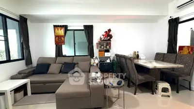 Modern living room with stylish furniture and dining area in open layout
