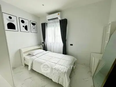 Modern minimalist bedroom with white decor and air conditioning