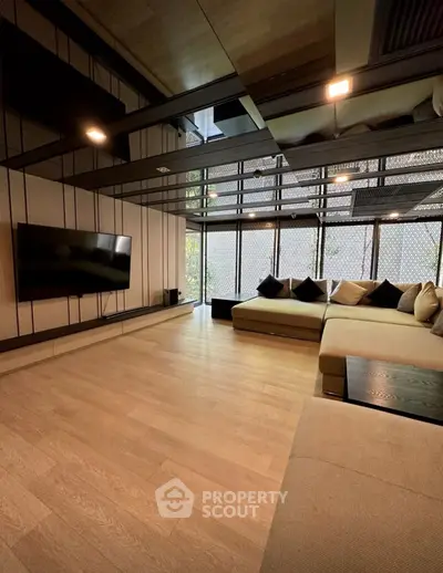 Luxurious modern living room with large sectional sofa and wall-mounted TV