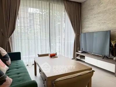 Modern living room with large TV, stylish furniture, and floor-to-ceiling windows.