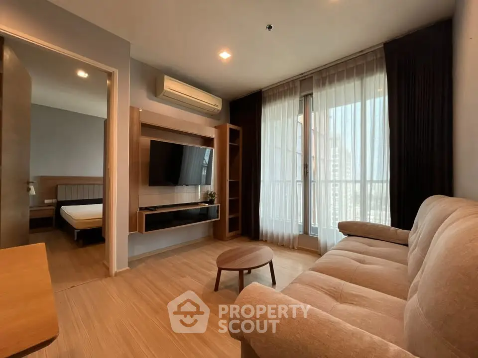 Modern living room with cozy sofa and wall-mounted TV in stylish apartment