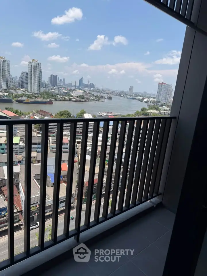 Stunning high-rise balcony view overlooking city skyline and river, perfect for urban living.