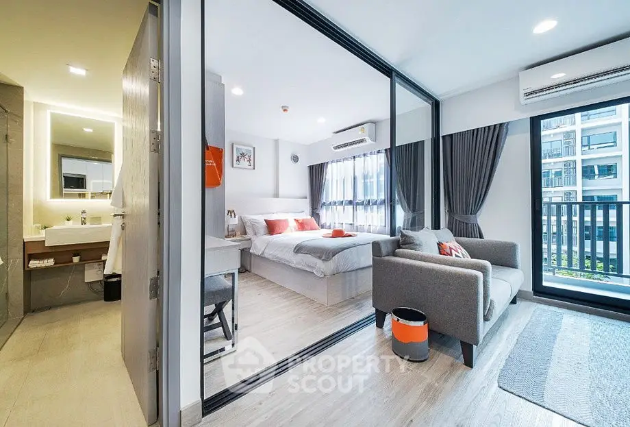 Modern studio apartment with open layout and stylish decor, featuring a cozy bedroom and living area.