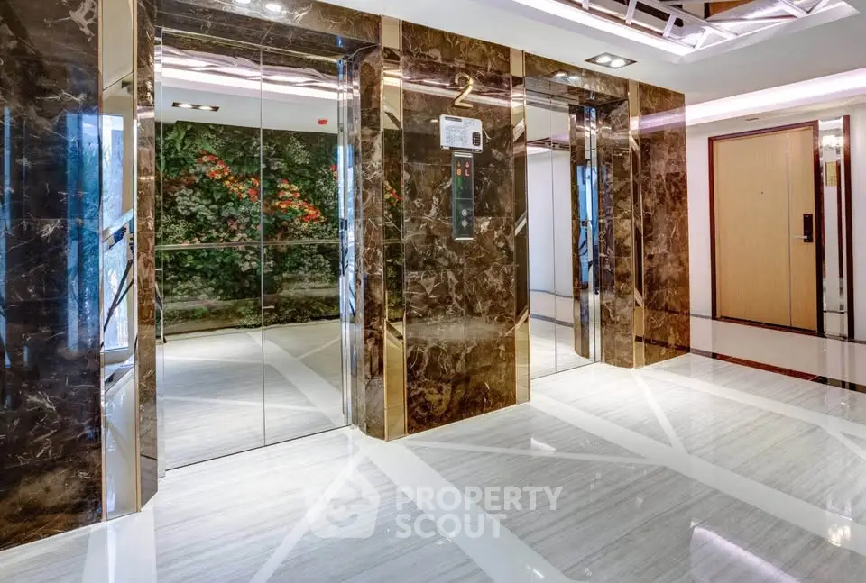 Luxurious marble elevator lobby with modern design and elegant lighting.