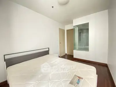 Spacious bedroom with modern design and large window for natural light