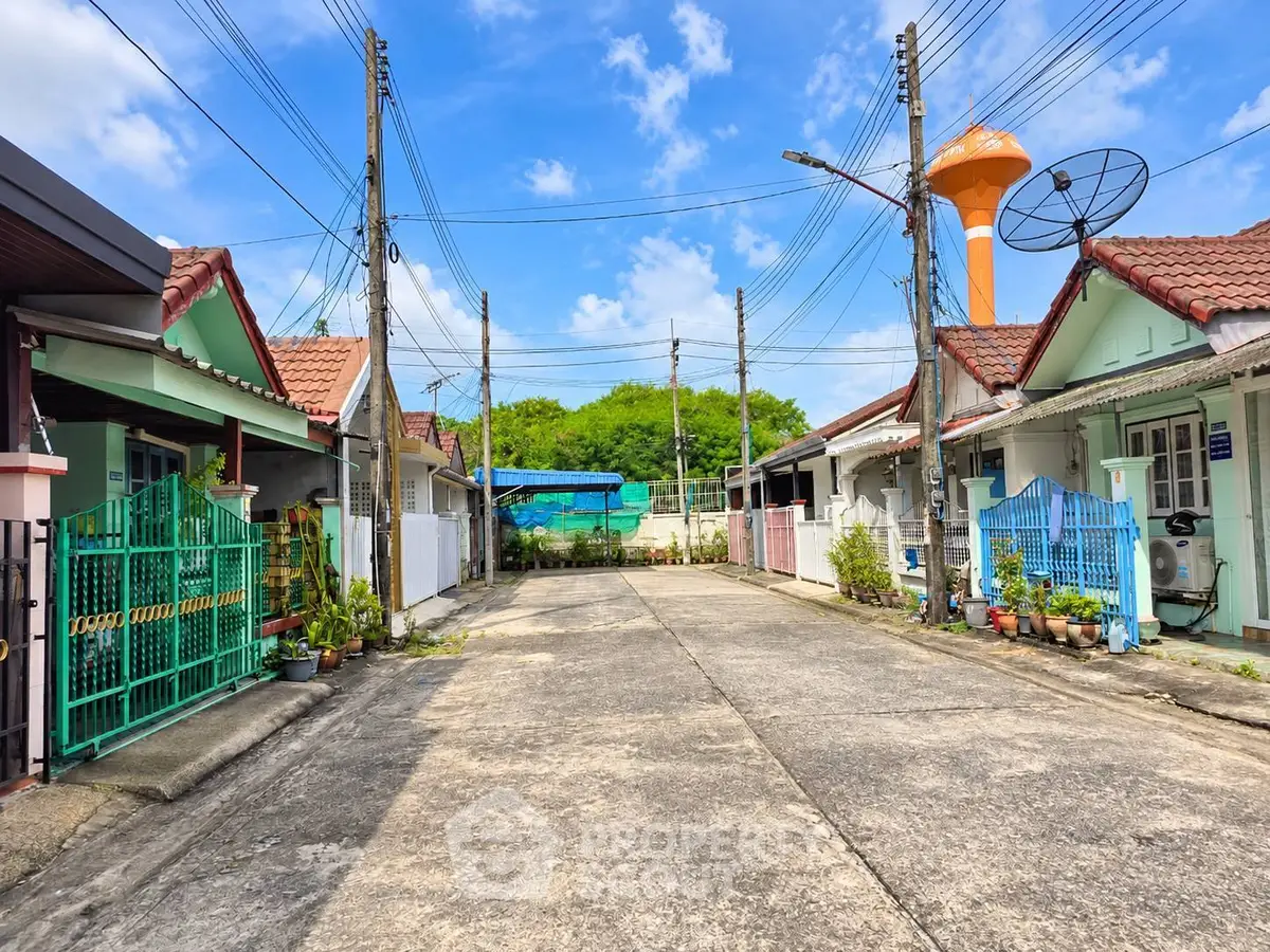 Charming residential street with colorful houses and lush greenery, perfect for serene living.
