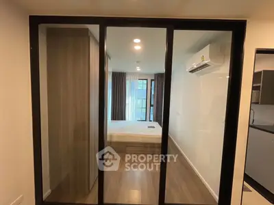 Modern bedroom with glass partition and air conditioning in a stylish apartment.