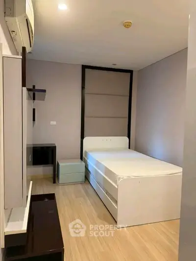 Modern minimalist bedroom with sleek furniture and ambient lighting