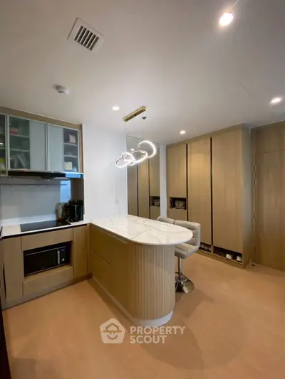 Modern kitchen with sleek cabinetry and stylish island lighting