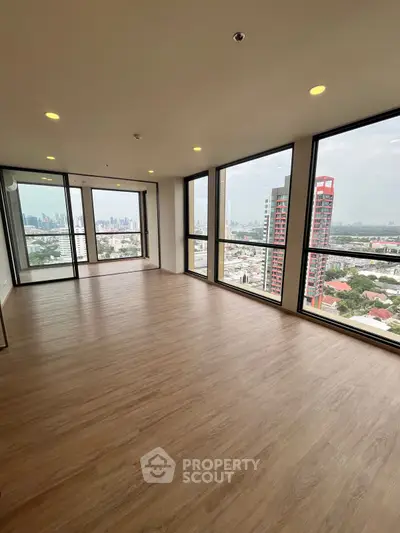 Spacious corner unit with panoramic city views and large windows in modern high-rise.