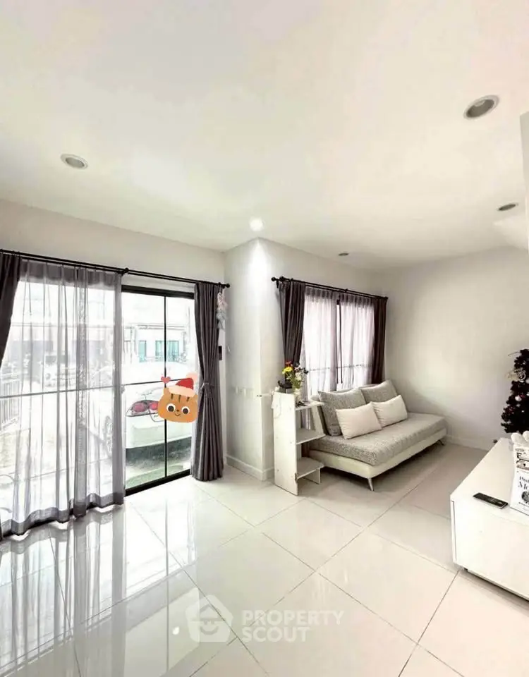 Bright and modern living room with large windows and sleek furniture