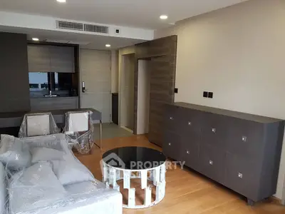 Modern living room with sleek furniture and hardwood floors in a contemporary apartment.