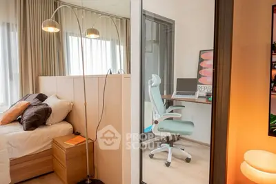 Modern bedroom with adjacent study area featuring stylish decor and natural light.
