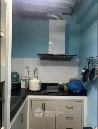 Modern kitchen with sleek cabinetry and efficient appliances, perfect for culinary enthusiasts.