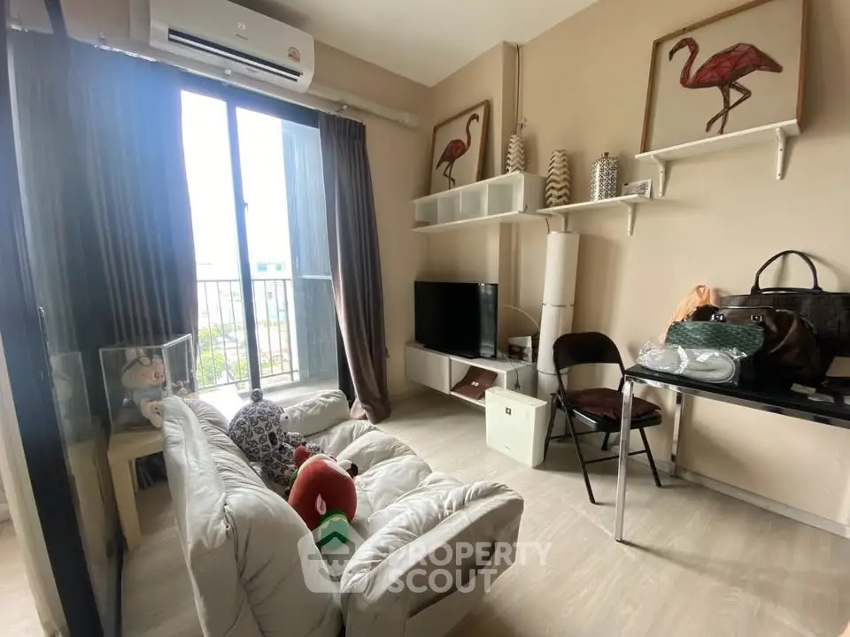 Cozy living room with modern decor and natural light, perfect for relaxation.