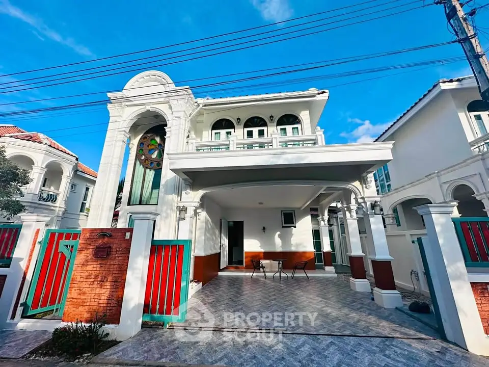 Stunning two-story villa with elegant arches and spacious driveway in a serene neighborhood.