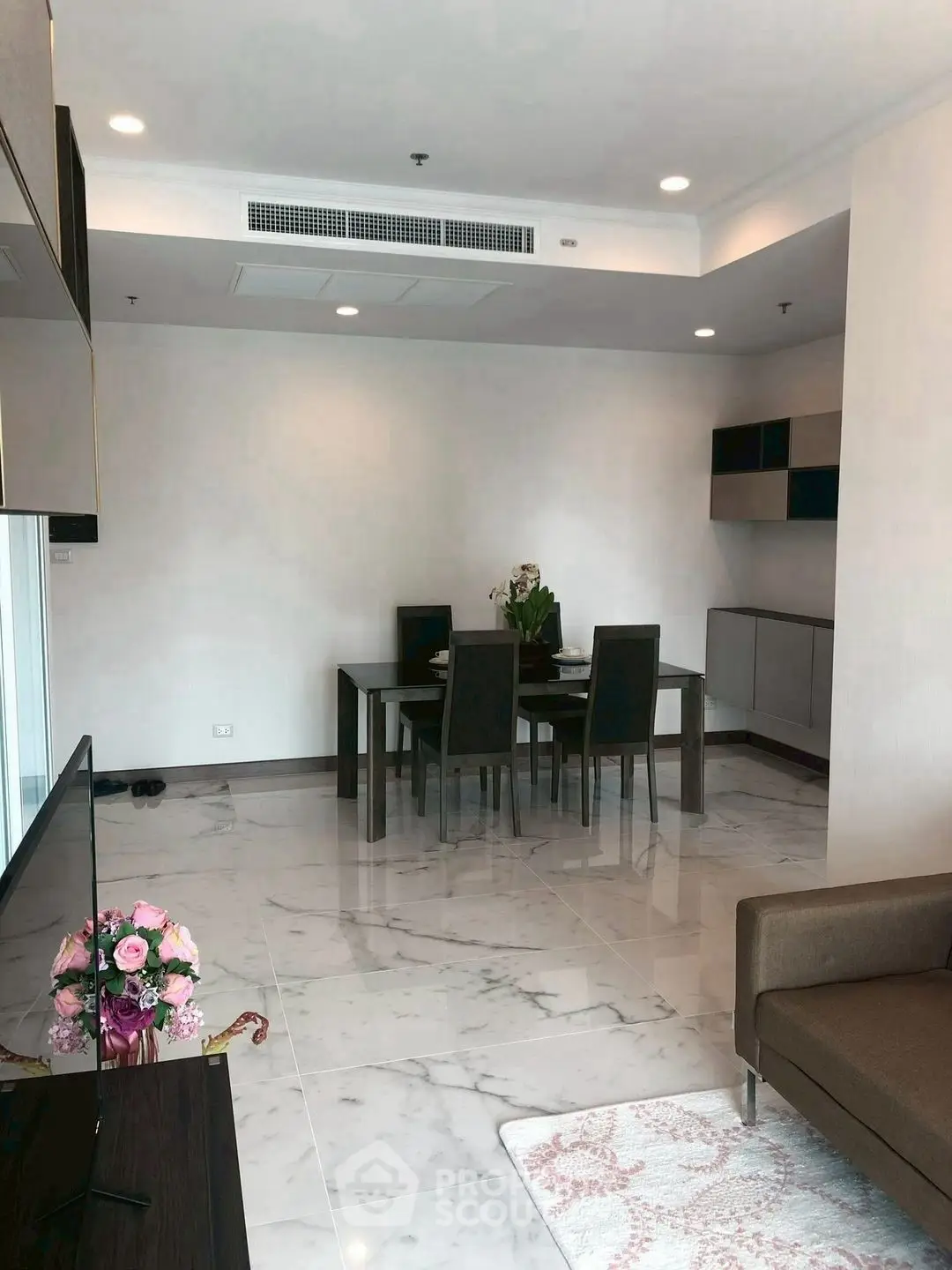Modern living room with elegant dining area and marble flooring