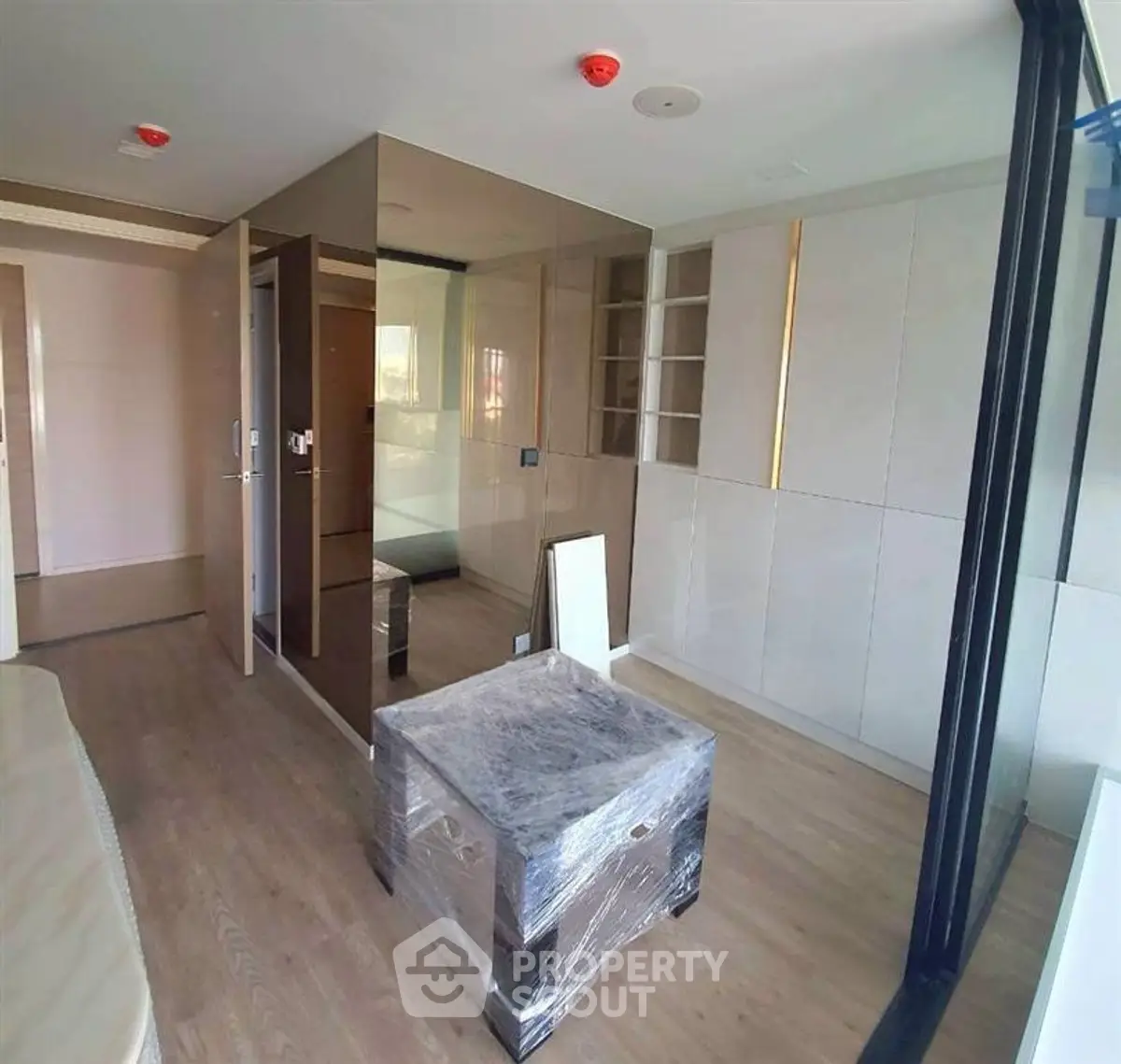 Modern apartment interior with sleek design and mirrored accents, showcasing contemporary living space.
