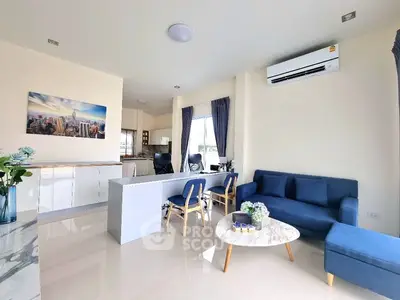 Modern living room with blue sofa and open kitchen layout