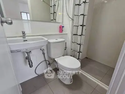 Compact modern bathroom with shower and sleek fixtures