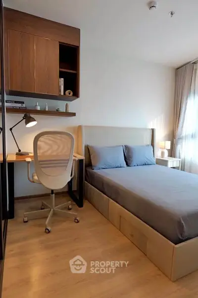Modern bedroom with sleek design, featuring a cozy bed, stylish desk, and ample natural light.