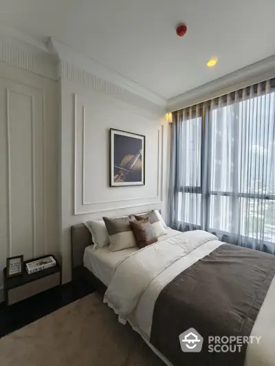 Luxurious bedroom with elegant decor and large windows offering stunning city views.