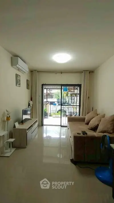 Spacious living room with modern decor and large window view