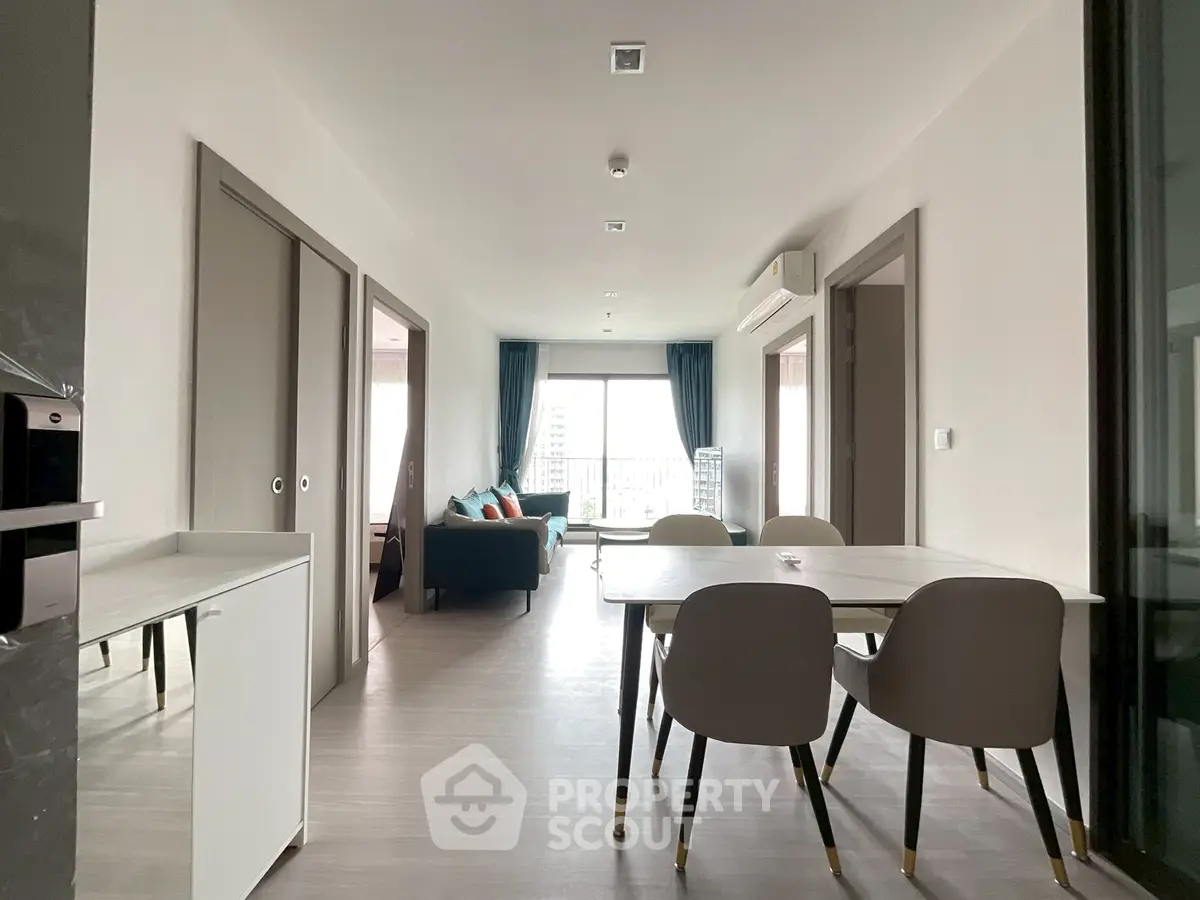 Modern open-plan living and dining area with stylish furniture and natural light.