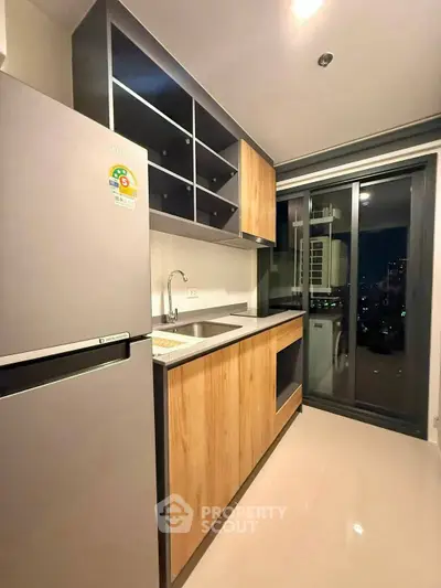 Modern kitchen with sleek cabinetry and city view from window