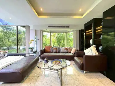 Luxurious living room with modern furniture and garden view, perfect for relaxation.