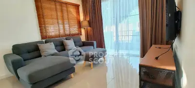 Modern living room with stylish sofa and large window for natural light.