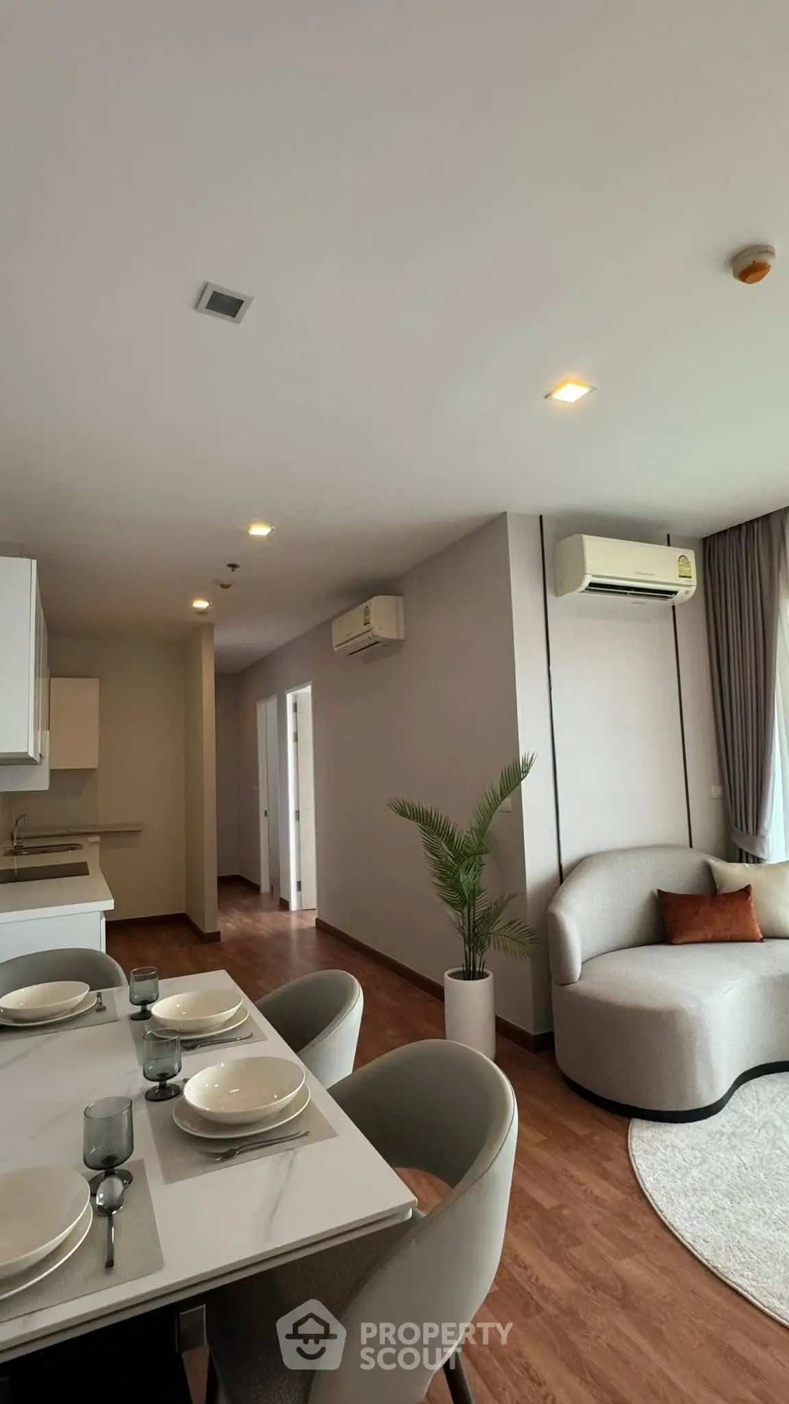 Modern open-plan living room with elegant dining area and cozy seating.