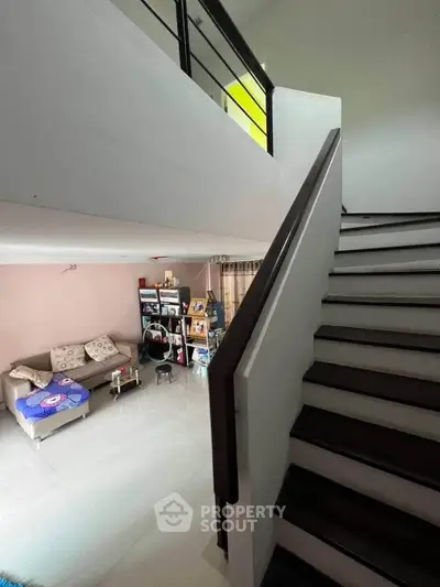 Modern duplex interior with staircase and cozy living area