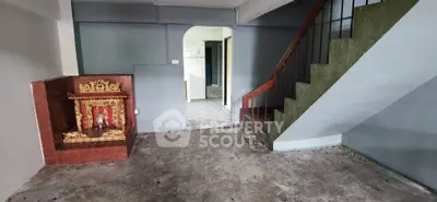 Spacious interior with unique staircase and decorative niche, ideal for creative renovation.