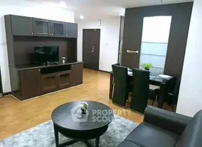 Spacious living room with modern furniture and dining area in a stylish apartment.