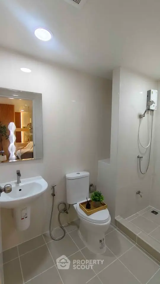 Modern bathroom with sleek fixtures and walk-in shower in a stylish apartment.