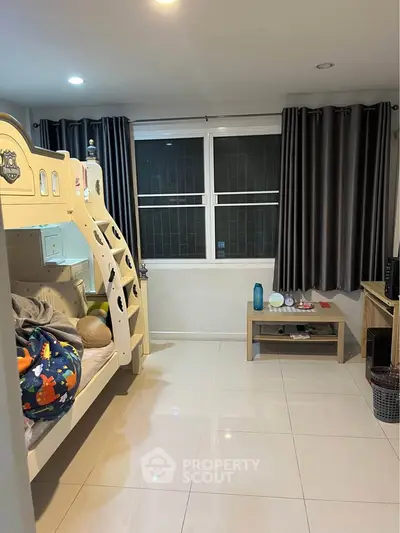 Charming bedroom with bunk bed and modern decor, perfect for a cozy living space.