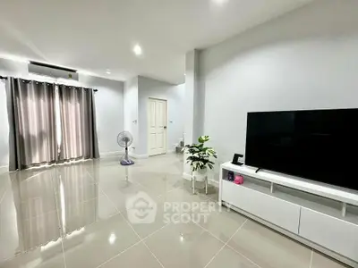 Spacious modern living room with sleek tile flooring and large TV unit