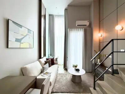 Modern living room with high ceilings and stylish decor in a luxury apartment.