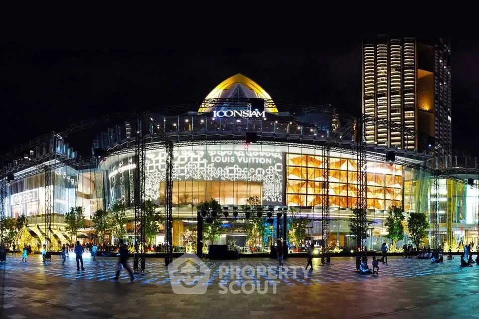 Stunning night view of Iconsiam shopping mall with illuminated facade and modern architecture.