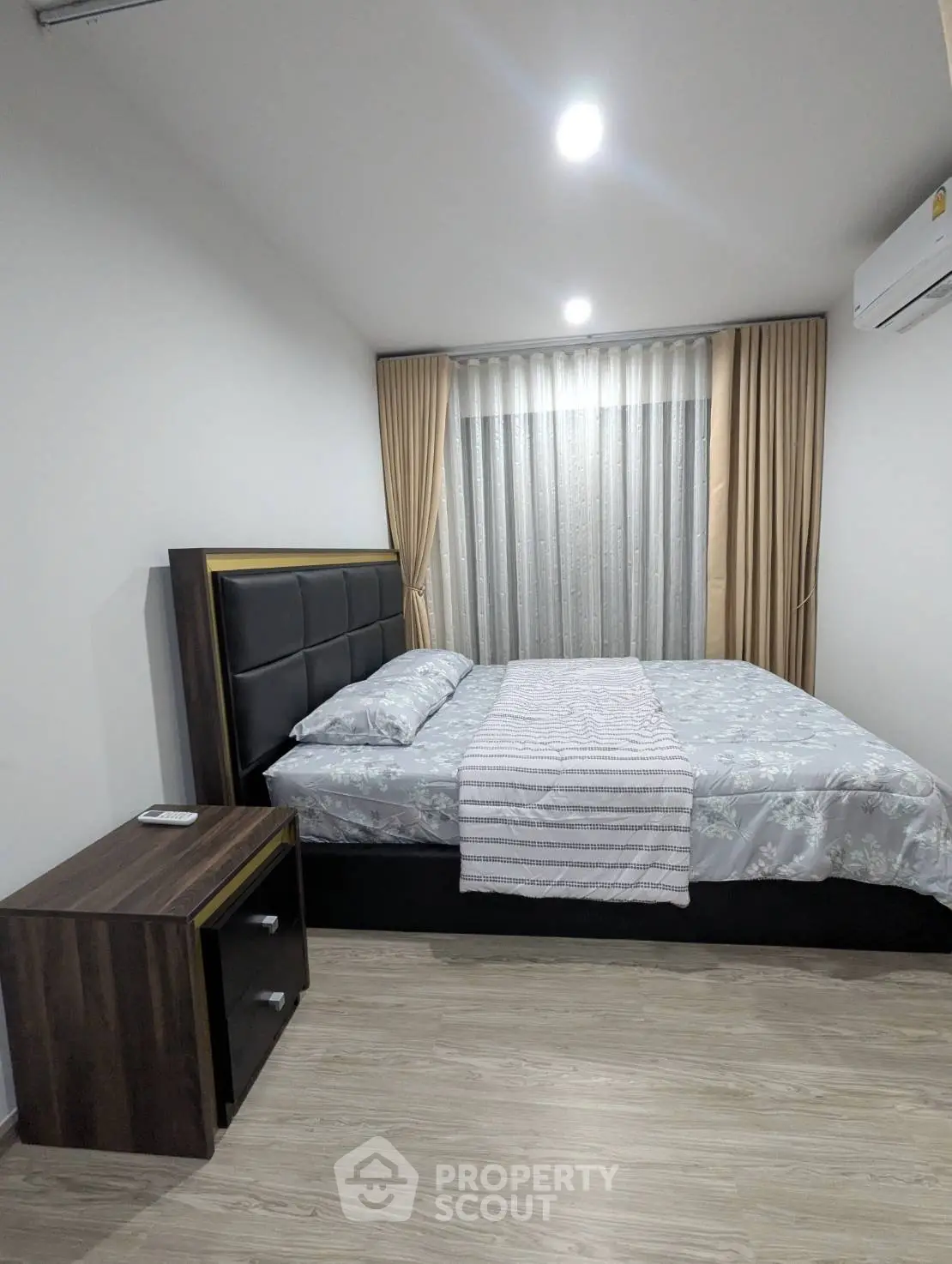 Modern bedroom with stylish decor and cozy ambiance, featuring a comfortable bed and elegant curtains.